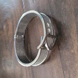 Silver tone buckle bracelet with faux chrystal paving
